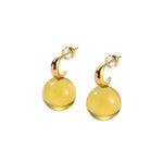 Pair of yellow earrings with gold accents on a white background