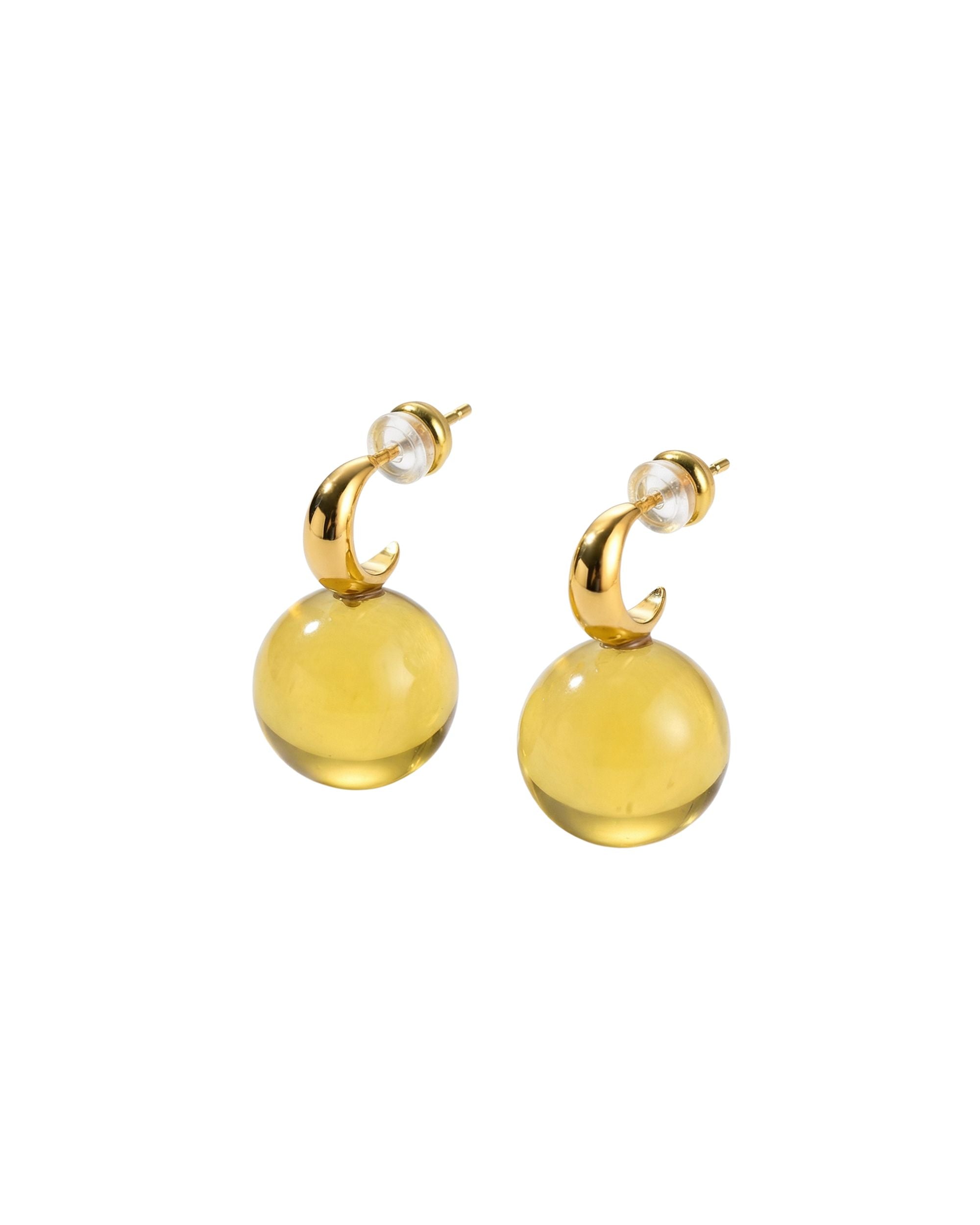 Pair of yellow earrings with gold accents on a white background