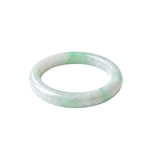 A slightly angled top-down shot of a light green and white jade bangle bracelet with a smooth, polished finish, shown on a plain white background.