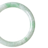 A close-up shot of a light green and white jade bangle bracelet shown against a plain white background.