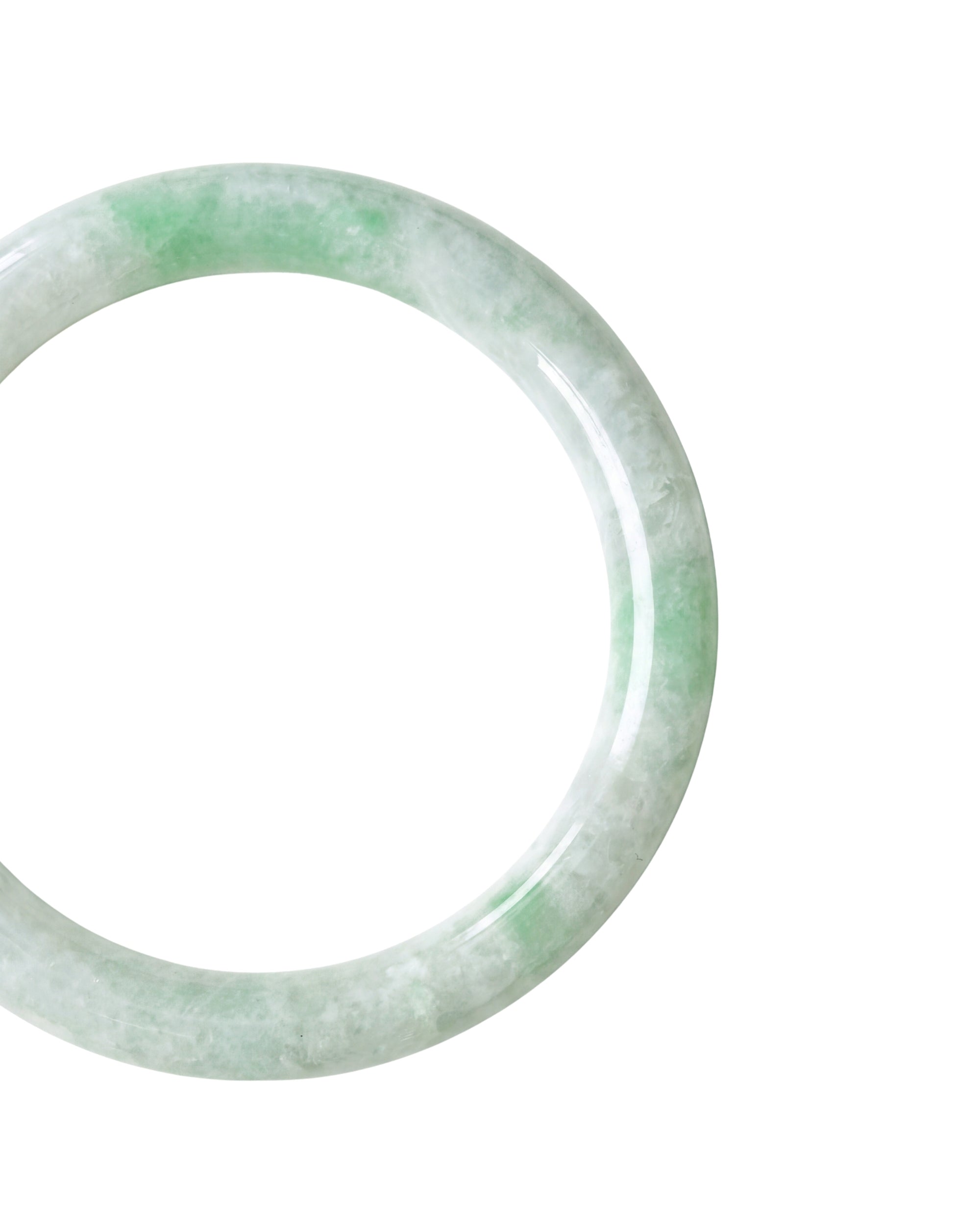 A close-up shot of a light green and white jade bangle bracelet shown against a plain white background.