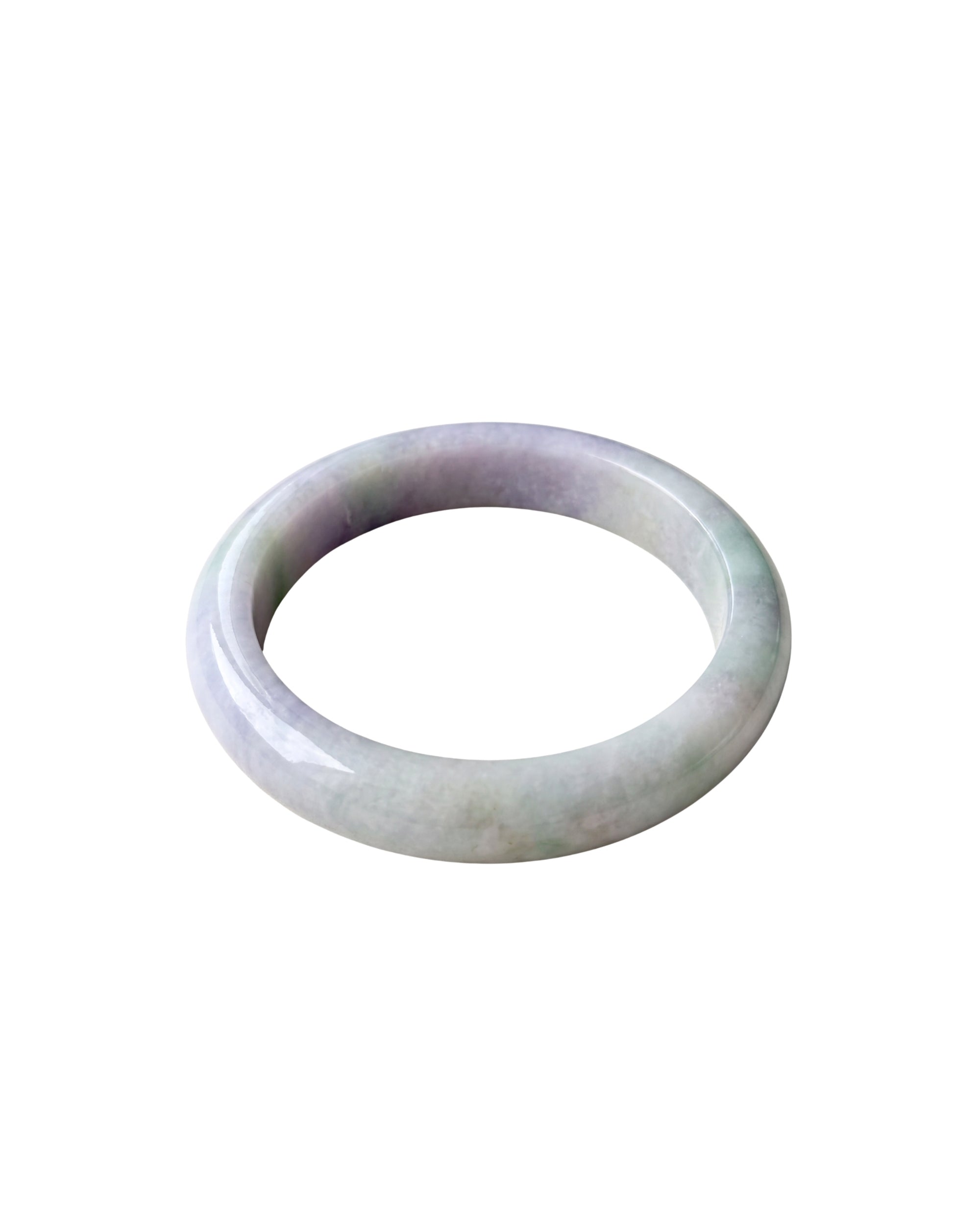 A slightly angled top-down view of a smooth, polished round bangle bracelet with a soft lavender-purple and pale green iridescent sheen, shown against a plain white background.