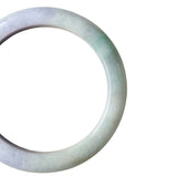 A close-up shot of a round jade bangle bracelet with a soft green and white color variation, shown against a plain white background.