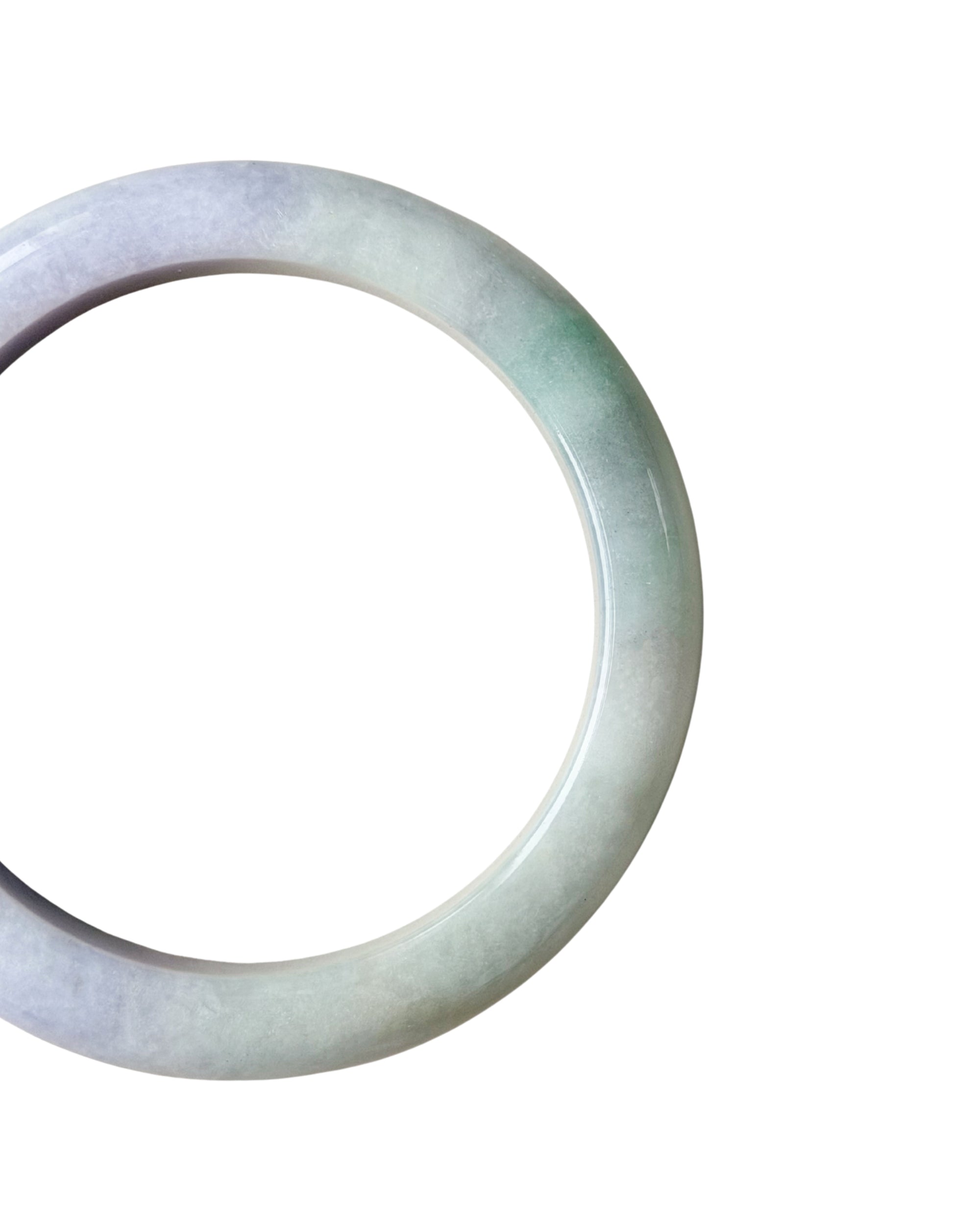 A close-up shot of a round jade bangle bracelet with a soft green and white color variation, shown against a plain white background.