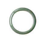 A flat lay shot of a single smooth, polished jadeite bangle bracelet in a soft light green color, shown against a plain white background.