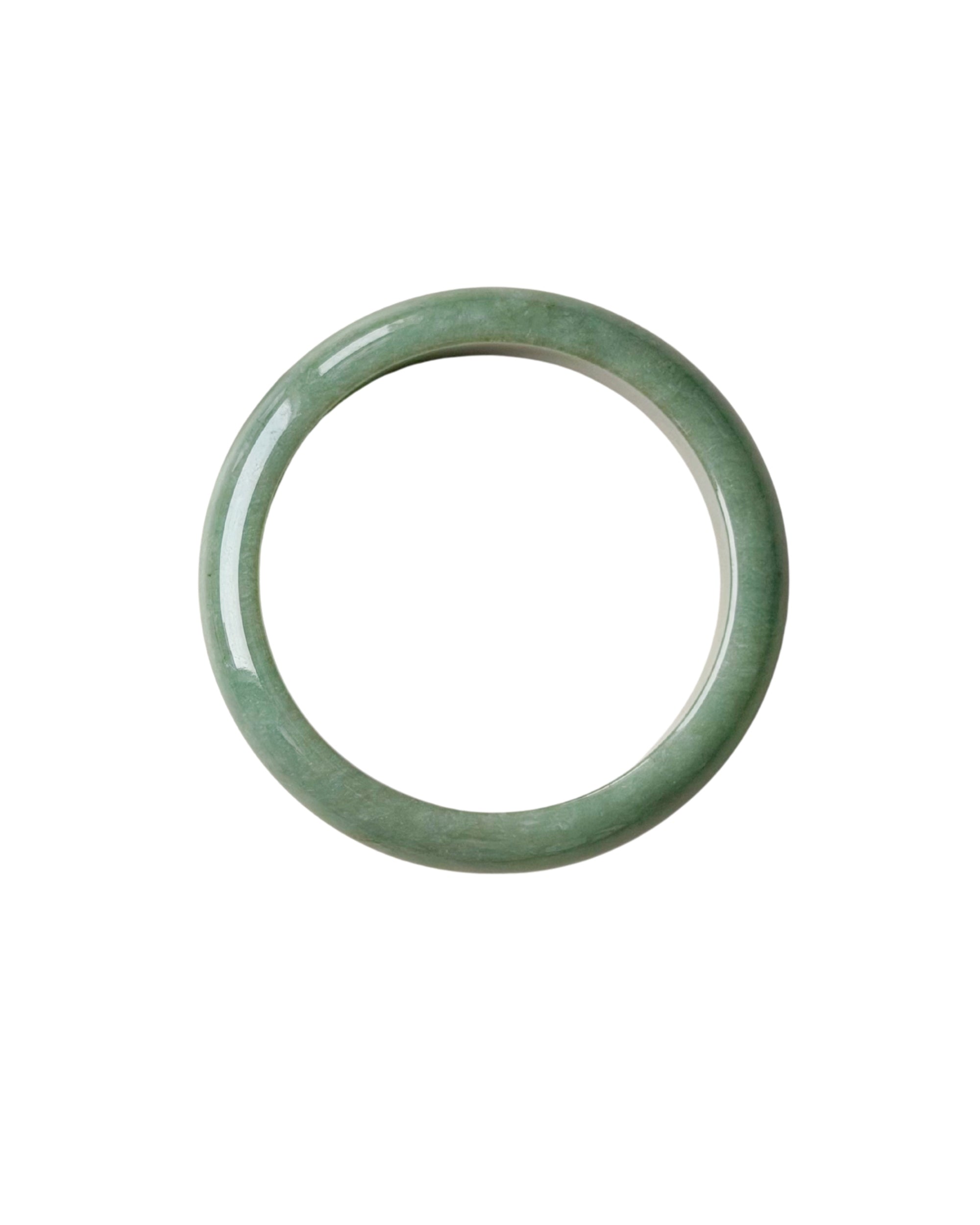 A flat lay shot of a single smooth, polished jadeite bangle bracelet in a soft light green color, shown against a plain white background.