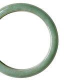 A close-up shot of a single light green jade bangle bracelet shown on a plain white background.