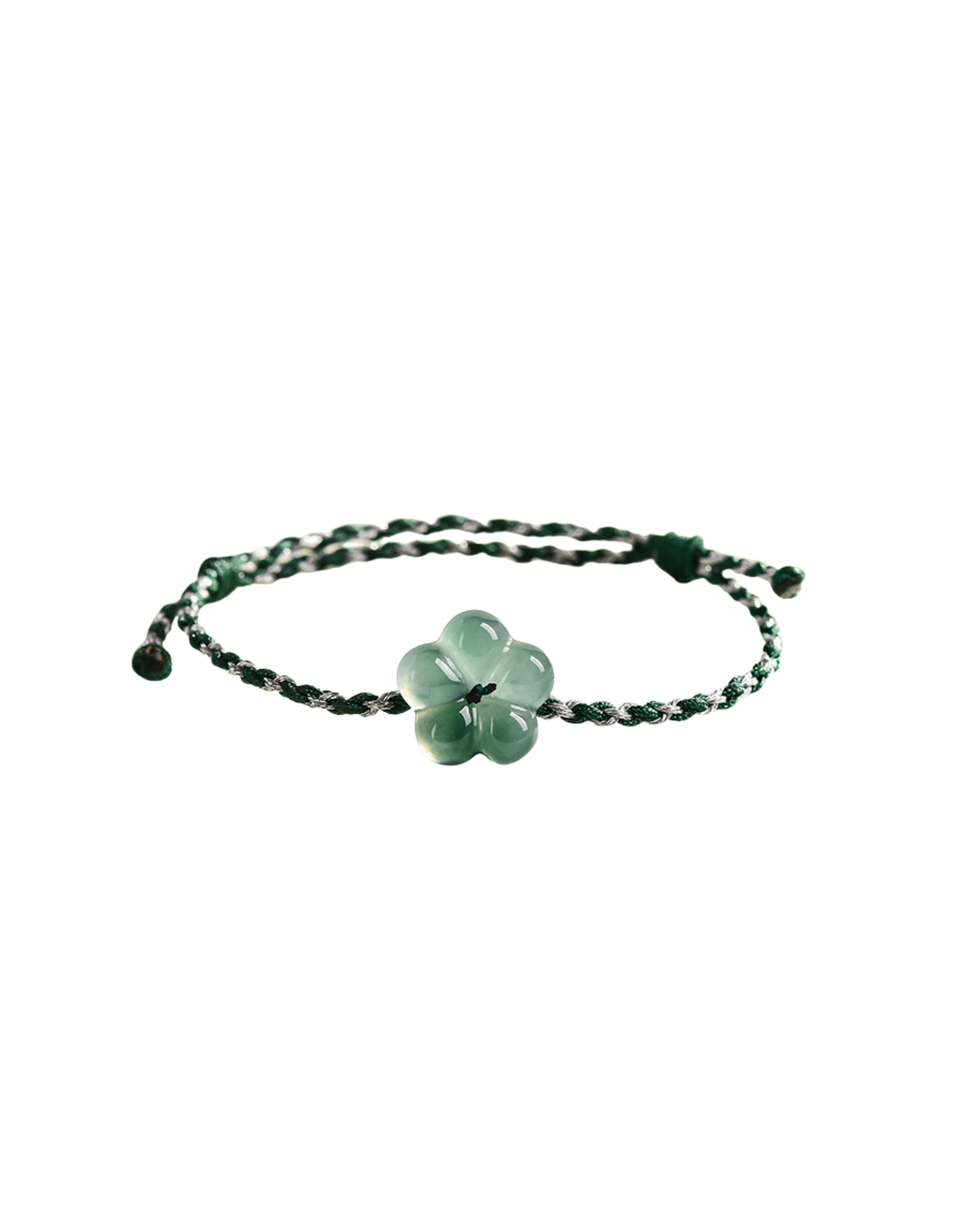 Green woven bracelet with a green flower-shaped jade charm on a white background, front view