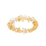Yellow beaded bracelet on a white background shot from 45 degree angle