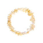 A stretch bracelet made of clear, irregular glass or crystal chips with a warm golden-yellow tint, displayed on a solid white background.
