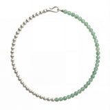 Green and silver beaded necklace showcasing a half-and-half arrangement of polished round beads with a silver clasp, shot on white background.