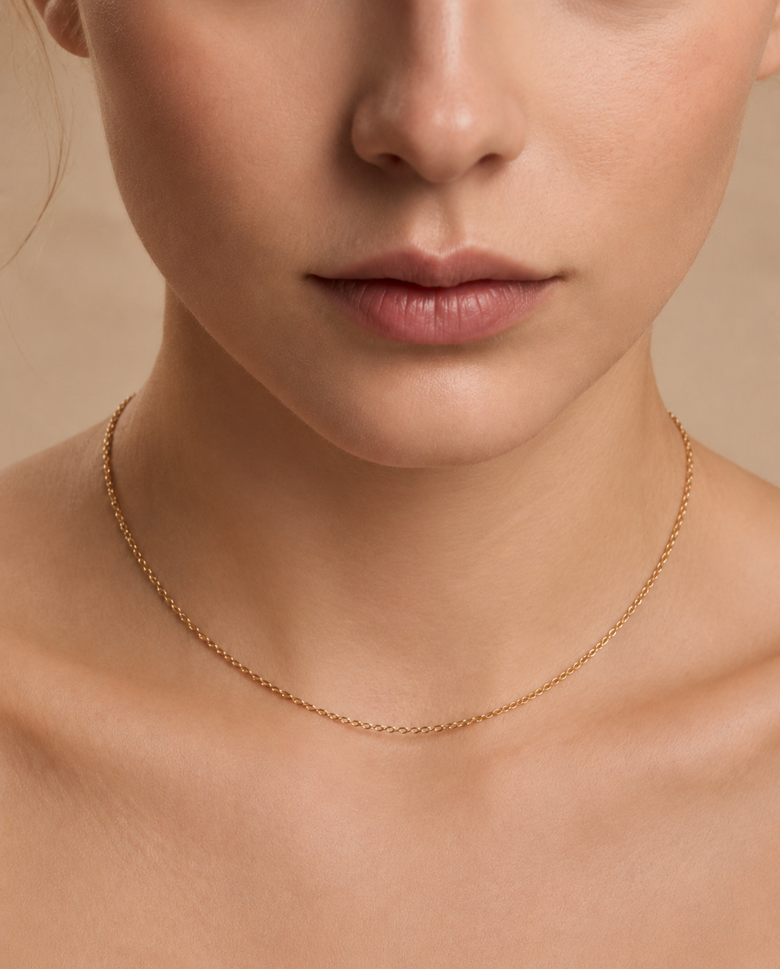 A woman wearing a skinny gold plated chain