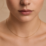 A woman wearing a skinny gold plated chain