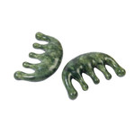 Two green stone combs on a white background