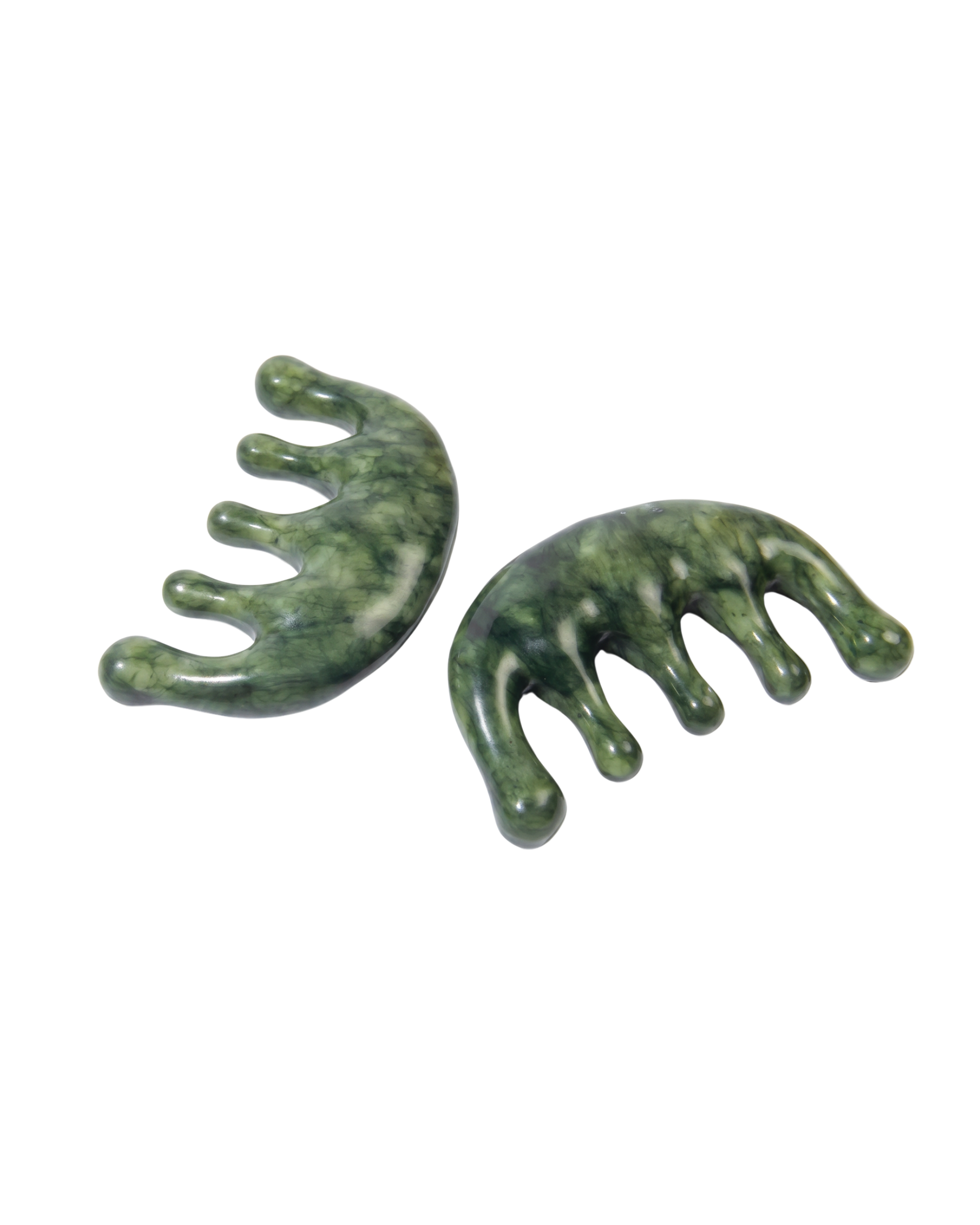 Two green stone combs on a white background