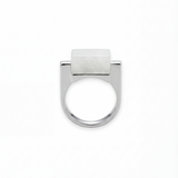 Silver ring with a white hanbai jade stone on a white background