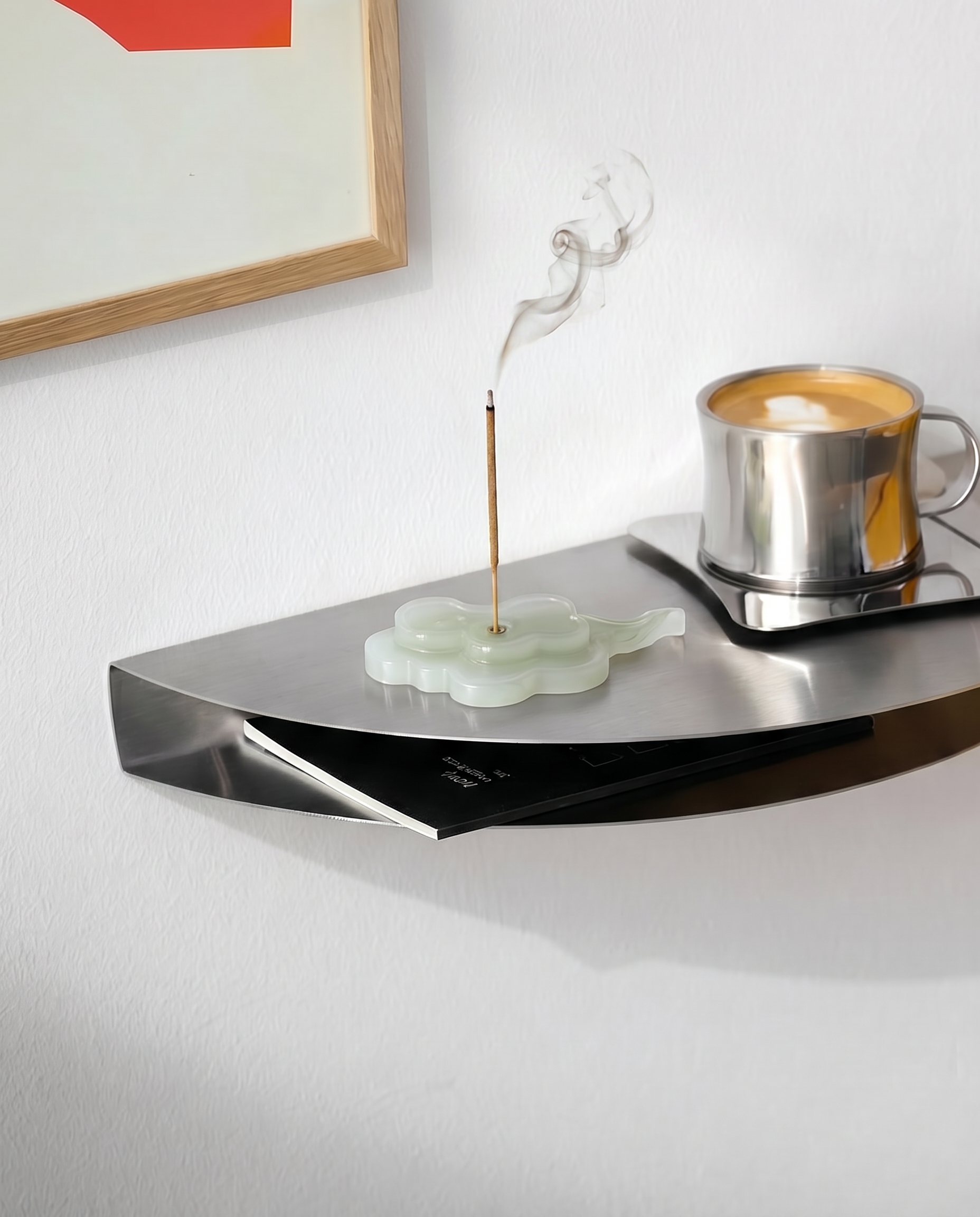 Modern wall-mounted shelf with a cup of coffee and incense stick on a white wall.
