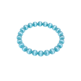 Slightly angled top-down view of a blue cat's eye beaded bracelet on a white background
