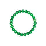 Flatlay shot of a green cat's eye beaded bracelet on a white background