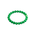 Slightly angled top-down view of a green cat's eye beaded bracelet on a white background