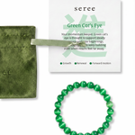 Green beaded bracelet with 'seree' packaging, green jewelry bag, and card on a white background
