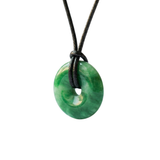 Green donut-shaped pendant on a black cord against a white background