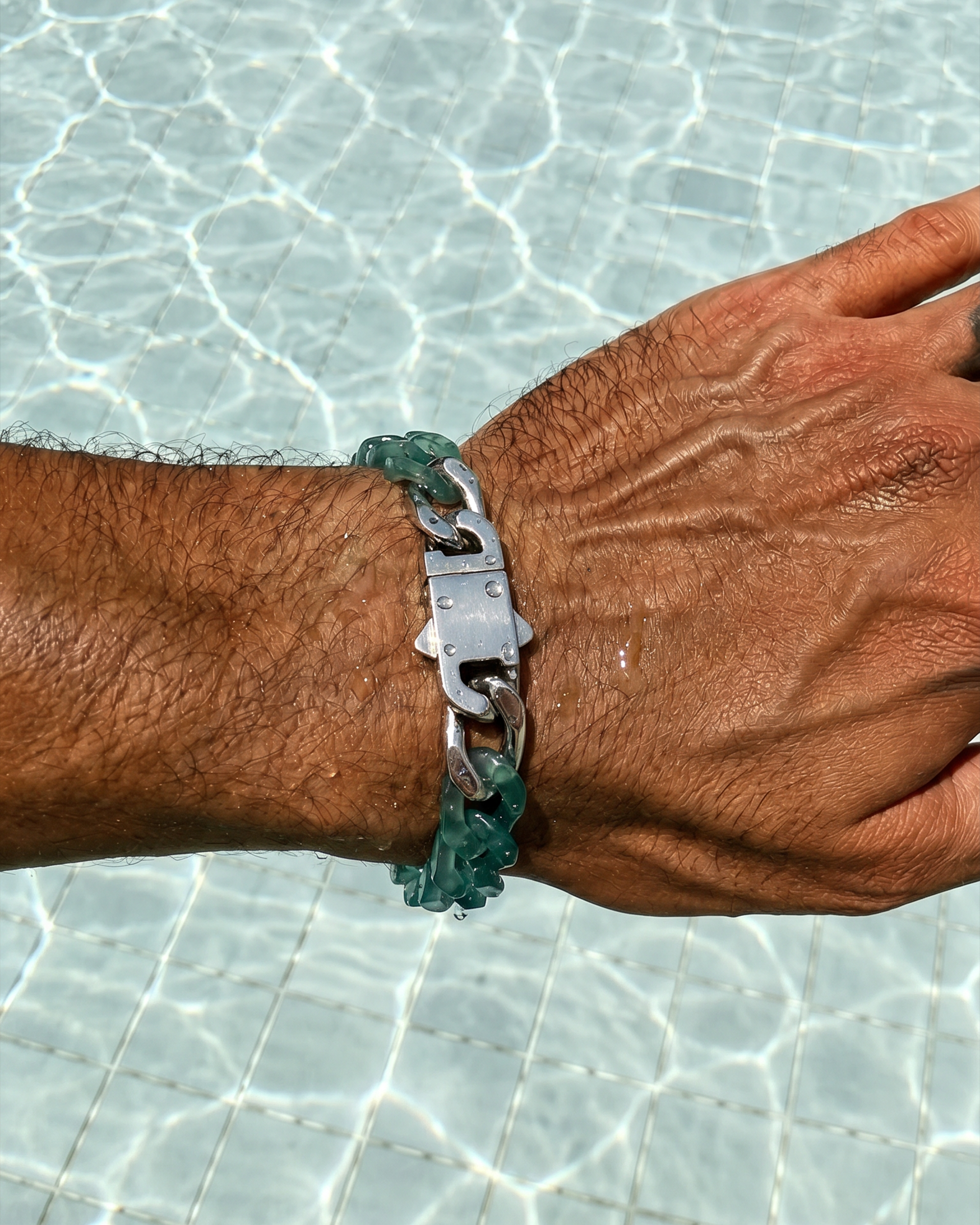 Hand wearing a bracelet with a clear background