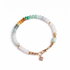 Multicolored beaded bracelet with a heart charm on a white background, top view