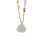 Necklace with a buddha jade pendant and multicolored beads on a white background, close-up