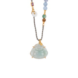 Necklace with a buddha jade pendant and multicolored beads on a white background, close-up