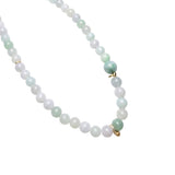 Jade bead necklace with mixed green and off-white jade stones, close-up