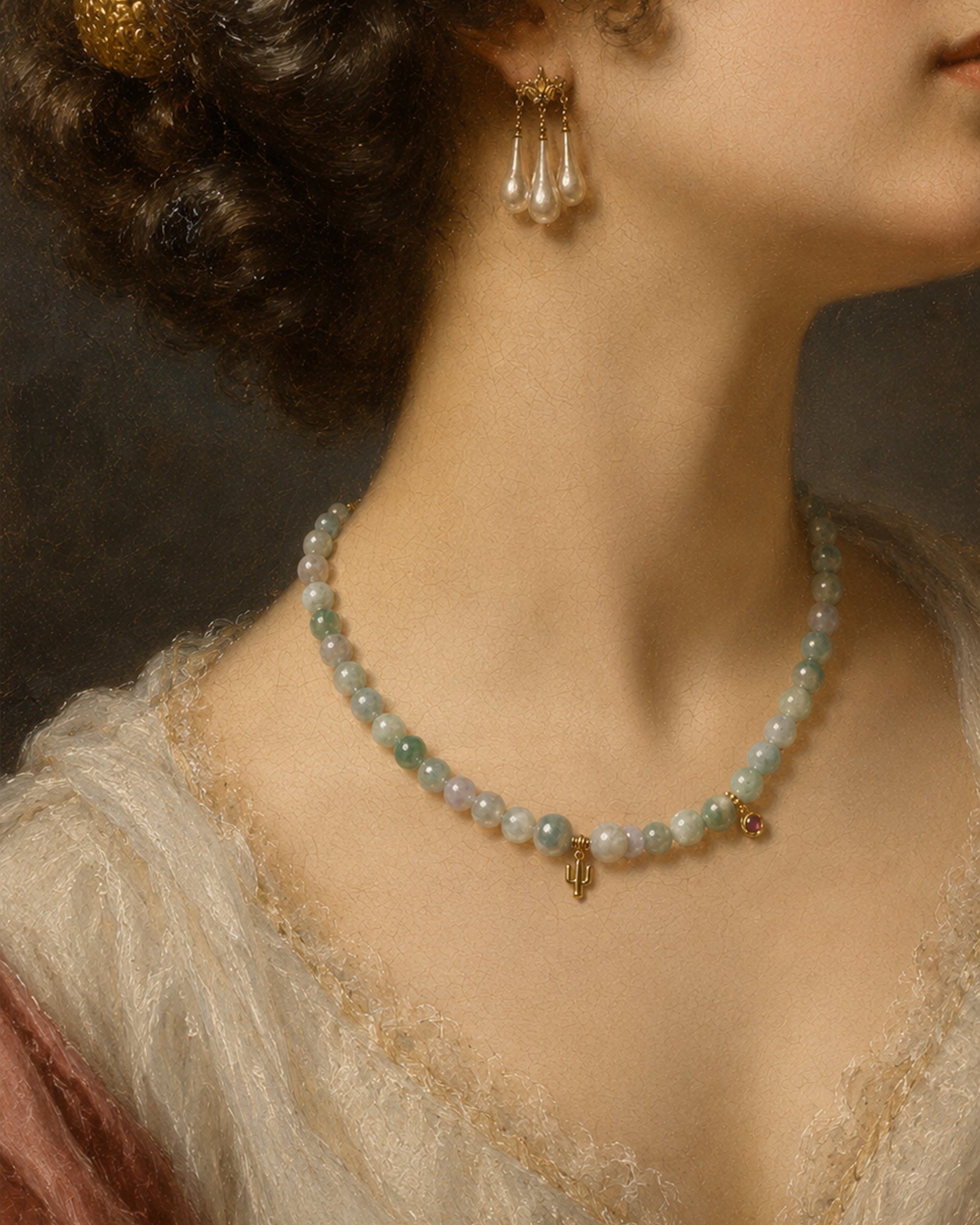 A close-up of a woman's neck and upper chest wearing a delicate beaded necklace with pale green and white pearls, gold-toned accents, and matching pearl drop earrings.