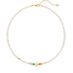 Pearl beaded necklace with gold and green jade beads on a white background