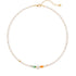 Pearl beaded necklace with gold and green jade beads on a white background