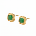Gold earrings with green gemstones on a white background